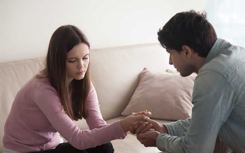 A couple enjoys a walk in the mountains. Couples therapy can decrease unhealthy conflict and help rebuild connection, trust, confidence, security, and intimacy.